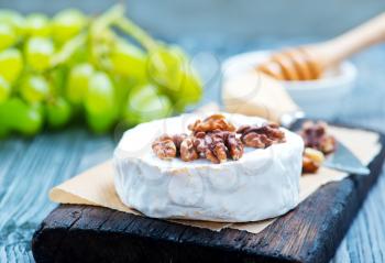 camembert with honey on board, stock photo