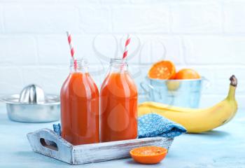 fresh fruit juice in bottle and on a table