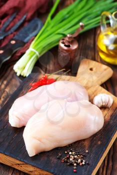 raw chicken fillet with spice and on a table