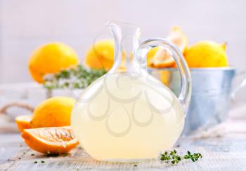 fresh lemon drink in glass jug and on a table