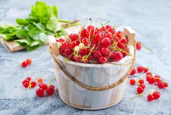 red currant in bowl and on a table