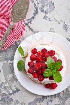cake with raspberry and cream on a table