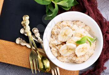 oat porridge with fresh banana in the bowl