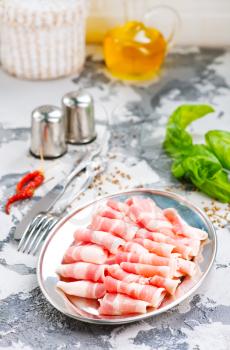 bacon with spice on the metal plate, stock photo