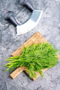 fresh dill on board and on a table