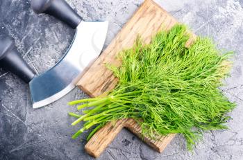 fresh dill on board and on a table