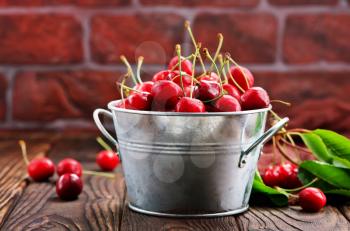 red cherry in bowl and on a table