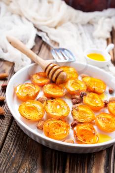 baked apricots with honey and nuts on a table