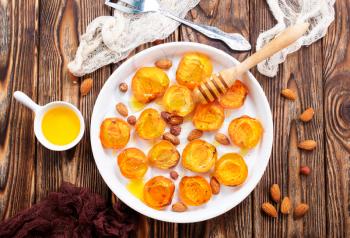 baked apricots with honey and nuts on a table