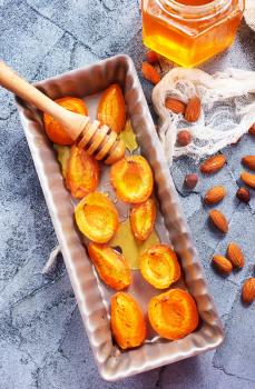 baked apricots with honey and nuts on a table