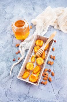 baked apricots with honey and nuts on a table