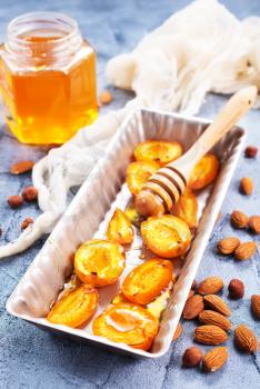 baked apricots with honey and nuts on a table