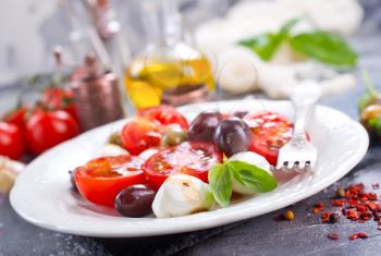 caprese salad on plate and on a table