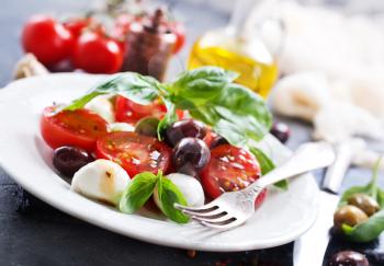 caprese salad on plate and on a table