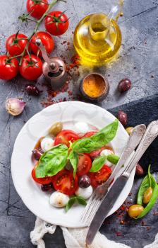 caprese salad on plate and on a table