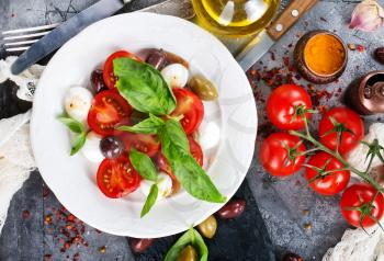 caprese salad on plate and on a table