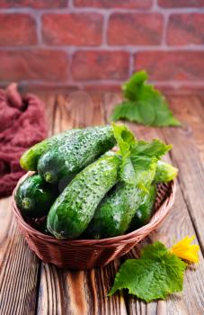 cucumbers in basket and on a table