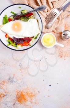 breakfast on plate, fried egg with salad