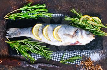 raw fish and salt and spice on a table