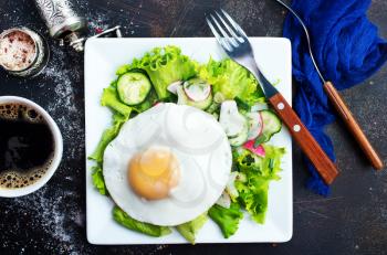 breakfast on plate, fried eggs and fresh salad