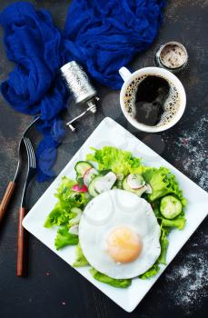breakfast on plate, fried eggs and fresh salad