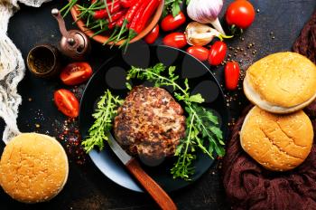 Products for preparation of burgers: buns, tomatoes, sauce, cutlets