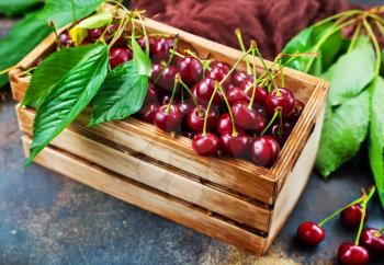 Fresh cherry, Cherries with leaves in wooden box 