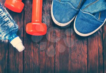 sport shoes and water on the wooden table