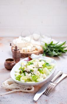 salad with oil and cheese in the bowl