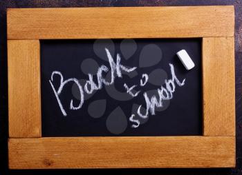 small chalkboard on a table, school supplies