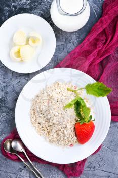 oat flakes with strawberry on white plate