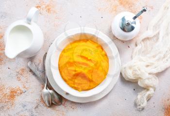 pumpkin porridge in bowl and on a table