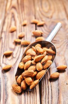 dry almond on the wooden table, stock photo