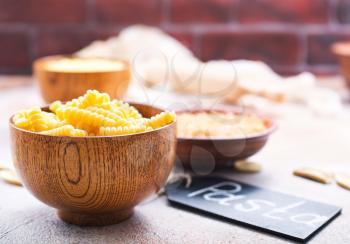 raw pasta in bowls and on a table