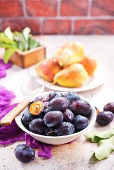 fresh plums on a table, stock photo