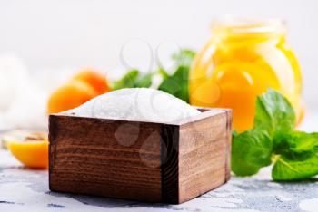 sugar and apricots on a table, ingredients for cooking jam