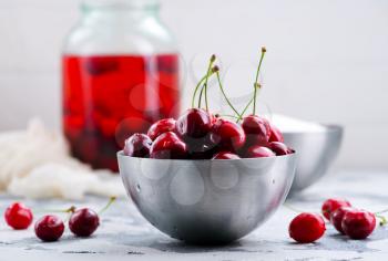 cherry compot  and fresh cherry in metal bowl