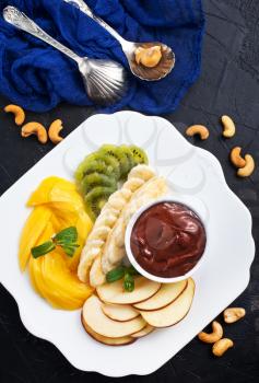 fresh salad of fruits, salad with fruits and chocolate sauce, stock photo