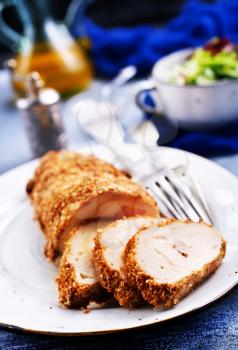 Baked rolls of chicken fillet. Home stuffed chicken rolls on white plate