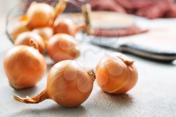  fresh raw onions in a basket, stock photo