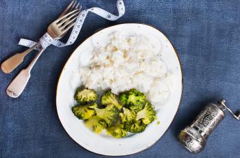boiled white rice and broccoli on plate, diet food,stock photo