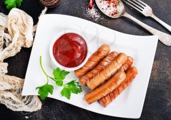 homemade sausages, sauces ketchup, grilled sausages with sauce