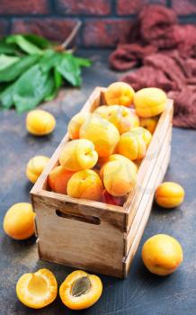 fresh apricot in wooden box, apricots on a table