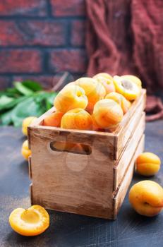 fresh apricot in wooden box, apricots on a table