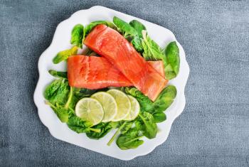 salmon with lemon and fresh spinach, diet food