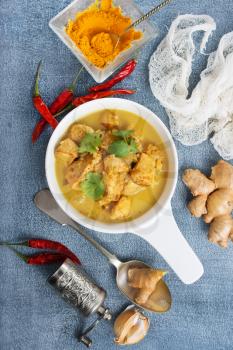 chicken curry in white bowl on a table