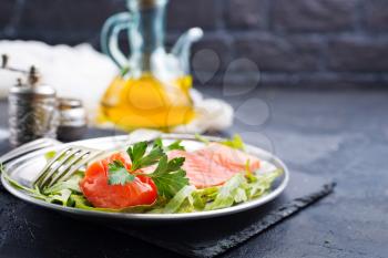 salmon fish with fresh salad on plate