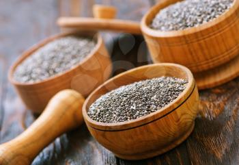 Chia seeds in bowls and on a table