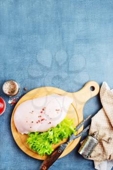 raw chicken fillet with spice and salt