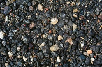 Black dirty broken stones background, macadam